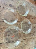 Overhead view of all four round glass baking pieces