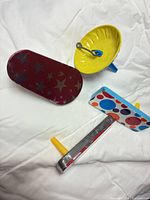 Front view showing spinning top and two patterned noisemakers