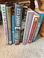 All eight books standing upright spines visible