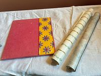 Album and two wallpaper rolls overview