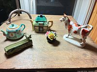Group shot of all five porcelain and ceramic items on table