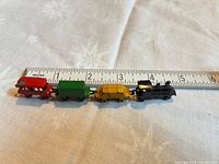 Entire 4-piece train aligned by ruler showing total length