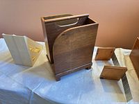 Group view of wooden magazine caddy, plastic magazine file, bookend blocks and metal bracket