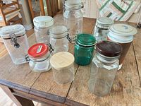 All ten storage containers displayed on table, showing variety of materials and lids