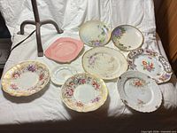 All 11 plates laid out showing variety of patterns and sizes