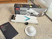 Mandoline slicer with food holder, manual and box displayed on floor