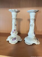 Full view of both porcelain candlesticks front