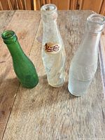Group shot of all three glass bottles standing on table