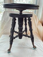 Full view of stool showing seat, legs, mechanism