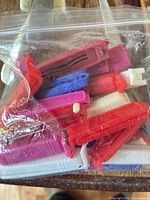Ziploc bag containing assorted plastic bag clips in multiple colors