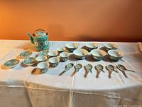 Entire 24-piece turquoise famille rose tea set laid out