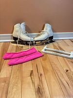 Full set: pair of skates, pink fabric covers, white plastic guards