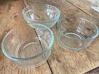 Three small clear glass bowls angled view