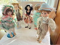 All five porcelain dolls on stands displayed together