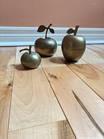 Three brass apple boxes with stems and leaves