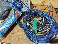 Coiled blue clothesline, lock, keys, packaging sleeve