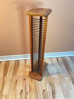Full view of CD tower front showing slat slots and finish