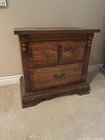 front view of solid wood nightstand showing three drawers and overall design