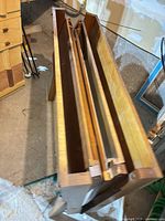 Folding picnic table collapsed, showing tabletop panels and bench parts