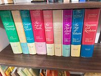 Front spines of all nine volumes on shelf