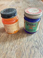Front view of both ointment jars showing colors and labels
