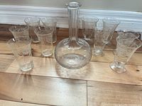 Decanter centered with eight of the glasses visible