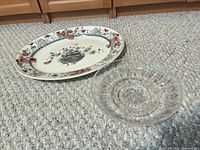 Oval floral platter beside clear cut glass bowl