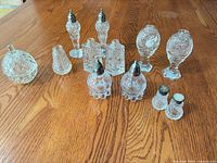 Group shot of all twelve shakers on wood surface