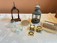 Group shot showing all eight items including lantern, wood stand, flower frog, two votive holders, three trinket boxes with packaging