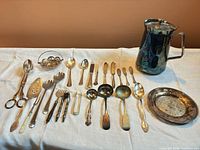 Full layout of all flatware, pitcher, tray and bowl on table