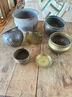 Full group of seven mixed-metal planters and saucer