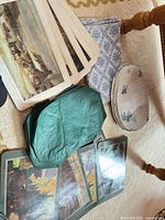 Mixed placemat sets laid out showing scenic melamine, green vinyl, cream floral and blue cloth designs