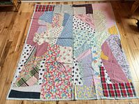 Full view of patchwork quilt laid flat showing entire pattern and size