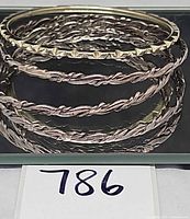 Stack of four sterling bangles on display card