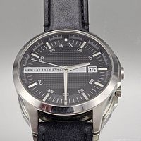 Front view of watch showing dial, case and part of strap