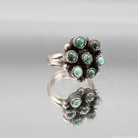 Top view showing seven green stones in floral cluster setting