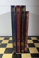 Spine view of four Easton Press leather-bound books