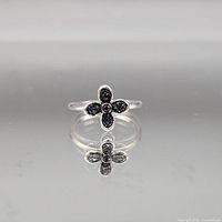 Full view of ring showing flower design and reflection