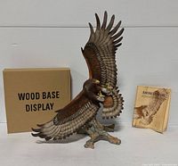 Full view of porcelain eagle with wood base, booklet and base box