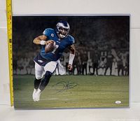 Full view of signed Jalen Hurts photo with tape measure showing roughly 20 inches height