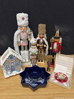 Group shot of all items: nutcrackers, gingerbread house, silver figurine, star bowl, boxed ornament