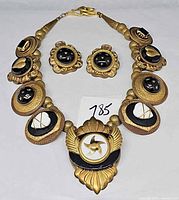 Full view necklace and earrings on white background