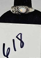 Full view of the ring on display cone showing opal cabochon and marcasite