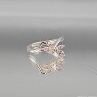 Full view of sterling silver ring with pink stones