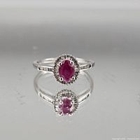 Front view of ring showing ruby, halo and band