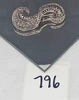 Top view of marcasite sterling brooch on display card