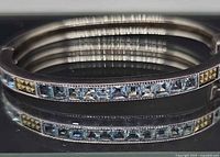 Front view of sterling silver bangle showing blue topaz and marcasite inlay