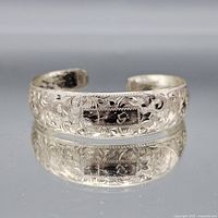 Front view of engraved sterling silver cuff bracelet
