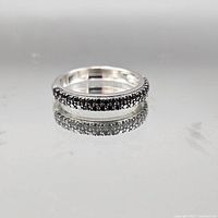 Full view of sterling silver band ring with black pavé stones
