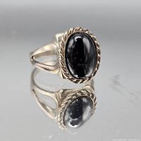 Front view of sterling silver ring with oval black cabochon